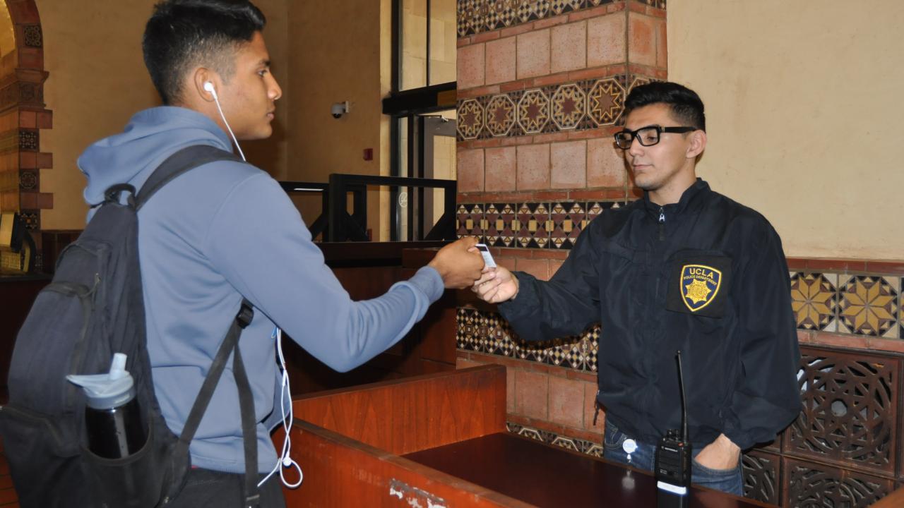 CSO officer checking a student's ID
